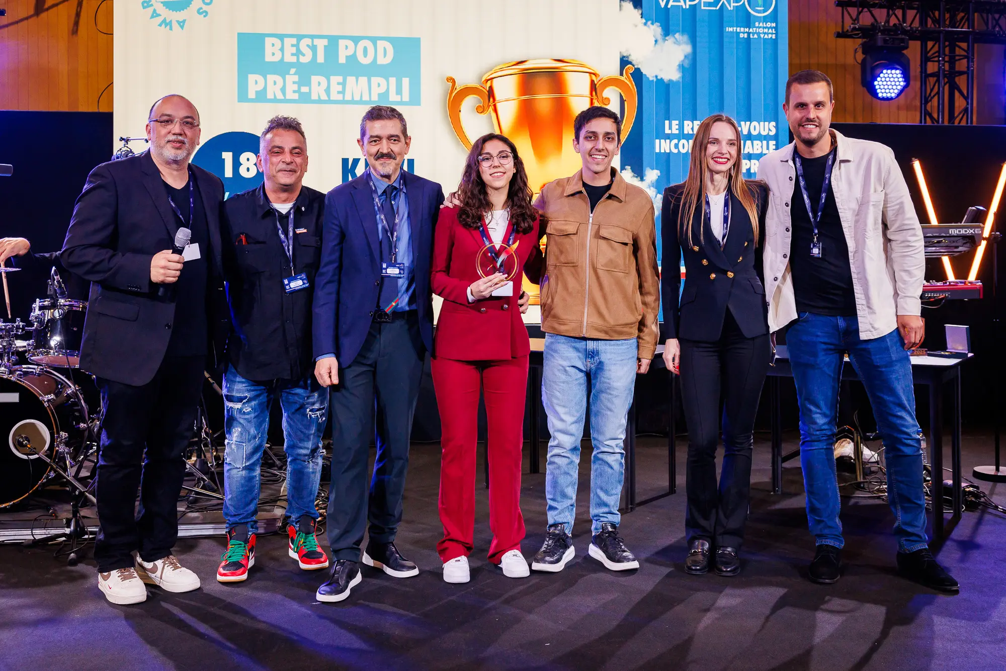 Équipe gagnante posant sur scène avec leur trophée lors de la remise du prix au Vapexpo Awards 2025